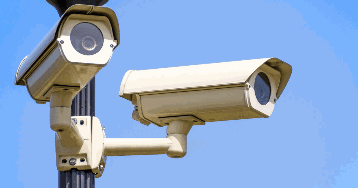 Two outdoor bullet cameras with sunshields on a pole under bright sun, showing features of the best security camera system for UAE heat